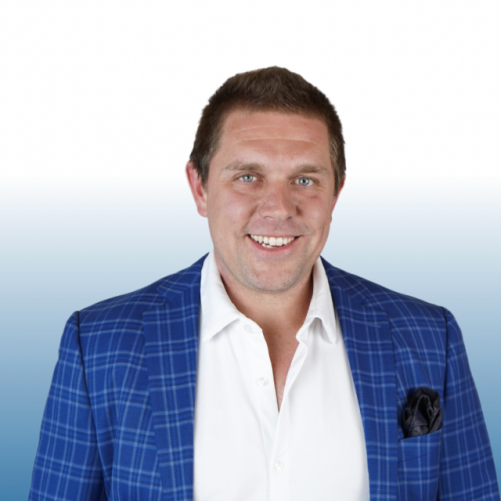 Equity team member in a blue plaid blazer with a white open-collar shirt, smiling